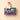 Vintage Dream Train Tin in red, green, and blue, featuring a Santa ornament and curated Cream & Crunchy chocolates. - AI generated text