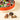 Venchi Natura Medium gift hamper: an elegant round presentation of artisanal, nut-filled chocolates in varied wrappers. - AI generated text