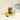 An elegant jar of Nougatine Chocolate Spread with a gold lid, served with a delicate spoonful on a polished gold platform. - AI generated text