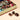 Venchi Vintage Dream Maxi Book filled with a curated selection of foil-wrapped chocolates and three unwrapped pieces. - AI generated text