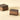 Cremino Espresso 9 pcs: two layered squares of dark chocolate and coffee, one revealing a textured hazelnut interior. - AI generated text
