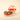 Natura Medium Gift Hamper: a refined round box of pistachio and hazelnut chocolates, elegantly adorned with a red ribbon. - AI generated text